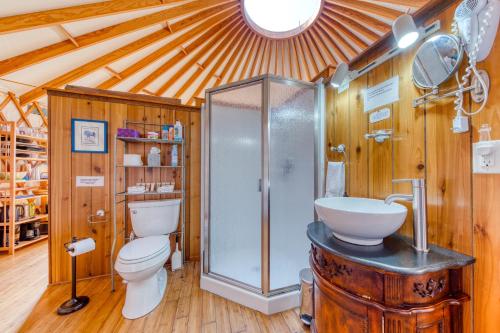 a bathroom with a shower and a toilet and a sink at Yurt on the Bay in Bay City