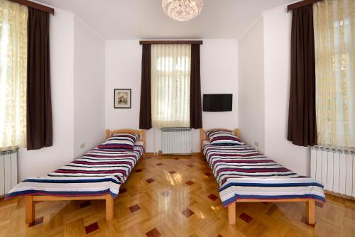 four beds lined up in a room at Vila Regina rooms in Karlovac