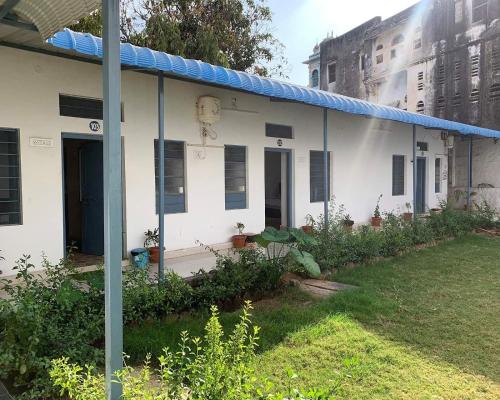 a white house with a painting on the side of it at IL Padrino hotel in Pushkar