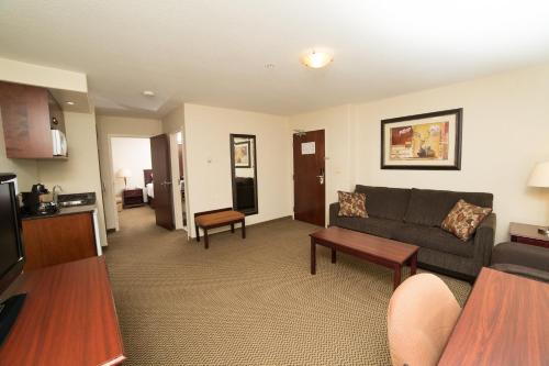 a living room with a couch and a table at Holiday Inn & Suites Lloydminster by IHG in Lloydminster