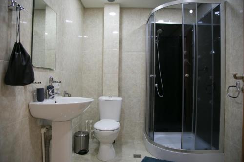 a bathroom with a toilet and a sink and a shower at KASA guesthouse Gyumri in Gyumri