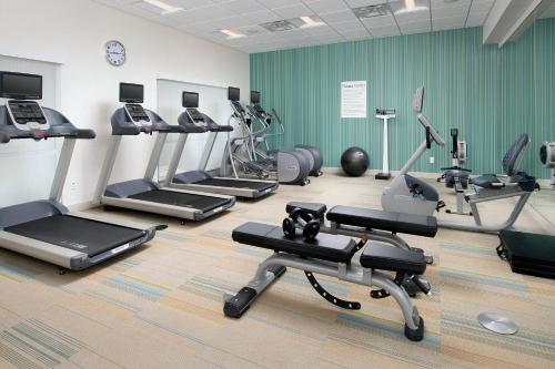 a gym with several treadmills and cardio machines at Holiday Inn Express & Suites - North Brunswick by IHG in North Brunswick
