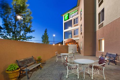 a patio with tables and chairs outside of a hotel at Holiday Inn Express & Suites Kings Mountain - Shelby Area by IHG in Kings Mountain