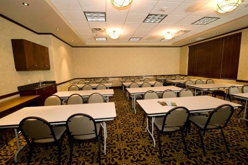 a classroom with rows of tables and chairs at Holiday Inn Hotel & Suites-West Edmonton by IHG in Edmonton