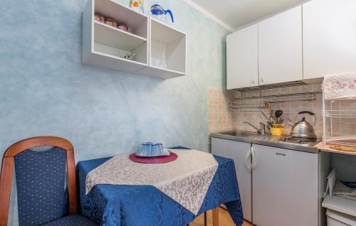 a kitchen with a table with a blue table cloth on it at Apartments and Rooms Laura in Pazin