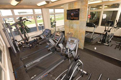a gym with two treadmills and two ellipticals at Holiday Inn Hotel & Suites-West Edmonton by IHG in Edmonton