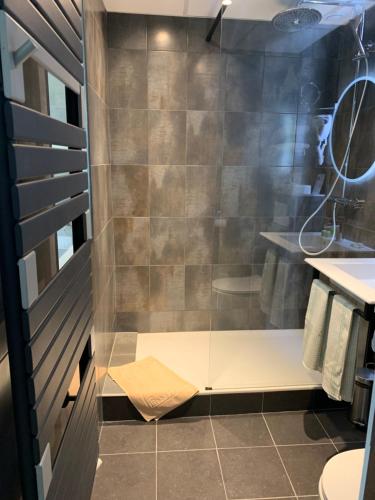 a bathroom with a shower with a toilet and a sink at Picardy Hôtel-Gare du Nord in Paris