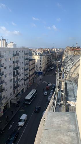 a view of a city street with cars and buses at Picardy Hôtel-Gare du Nord in Paris