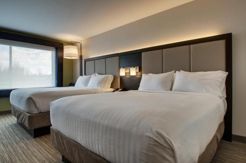 a hotel room with two beds and a large window at Holiday Inn Express & Suites - Mount Vernon by IHG in Mount Vernon