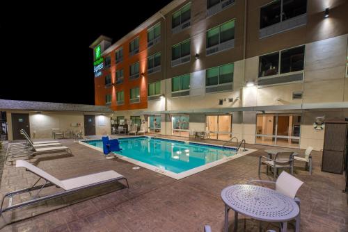 a pool in front of a hotel at night at Holiday Inn Express & Suites - Moses Lake by IHG in Moses Lake