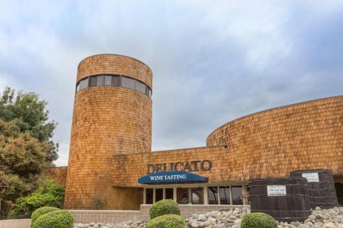 a brick building with a tower on top of it at Holiday Inn Express Hotel & Suites Manteca by IHG in Manteca