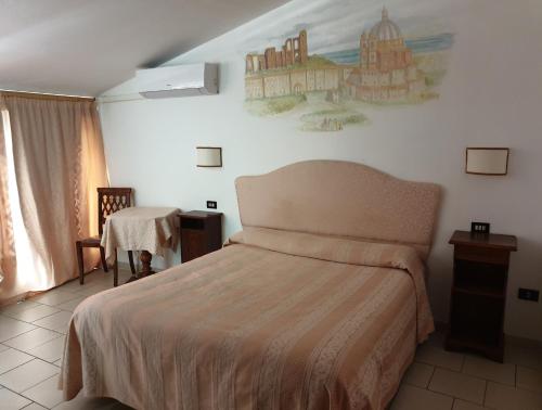 A bed or beds in a room at Hotel Ristorante Bagnaia