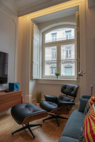 a living room with a window and two chairs at Lisbon Center Rua Augusta Modern Art Apartment in Lisbon