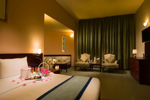 a hotel room with a bed with flowers on it at Masira Island Resort in Ḩilf