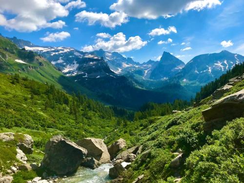 a view of a mountain valley with a river at Casa Vacanza in tipico Chalet di montagna in Varzo