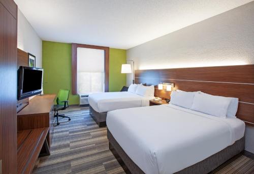 a hotel room with two beds and a flat screen tv at Holiday Inn Express & Suites Houston - Memorial Park Area, an IHG Hotel in Houston