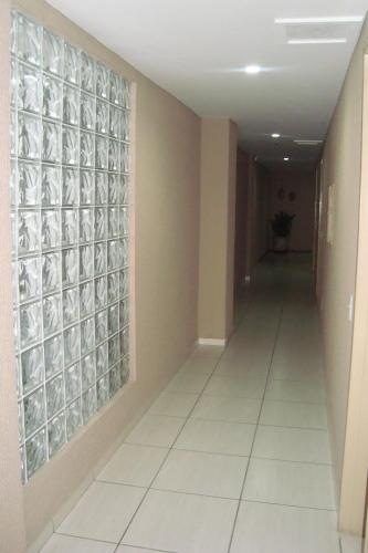 a hallway in a building with a glass wall at Villa Park Hotel Fortaleza in Fortaleza