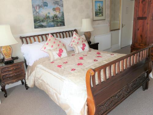 a bedroom with a bed and a dresser at The Montclare & Cumberland in Llandudno