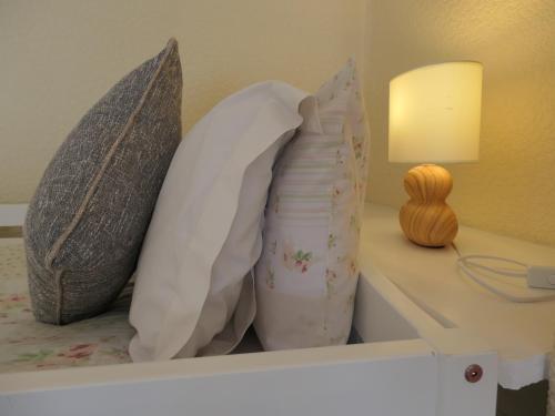 a bed with pillows on top of a shelf at The Cumberland in Llandudno