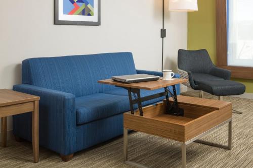 a blue couch and a table in a room at Holiday Inn Express Hotel & Suites White River Junction by IHG in White River Junction