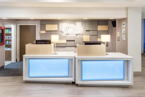 a lobby with two counters with blue lights at Holiday Inn Express Hotel & Suites Providence-Woonsocket by IHG in Woonsocket