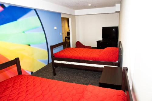 a hotel room with two beds and a tv at Holiday Inn Hotel & Suites Red Deer by IHG in Red Deer