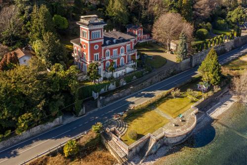 an aerial view of a mansion on a hill at Villa Niobe - Exclusive Lakefront Apartment With Private Beach in Stresa