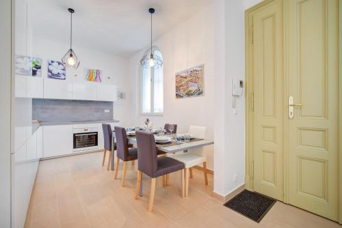 a kitchen and dining room with a table and chairs at Bishop Apartments in Brno