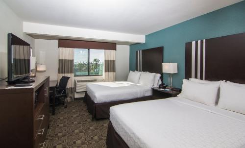 a hotel room with two beds and a television at Holiday Inn Express Hotel & Suites Carlsbad Beach by IHG in Carlsbad
