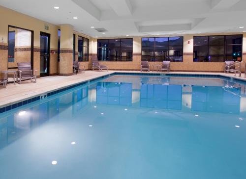 a large pool with blue water in a hotel lobby at Holiday Inn Express & Suites Logan, an IHG Hotel in Logan