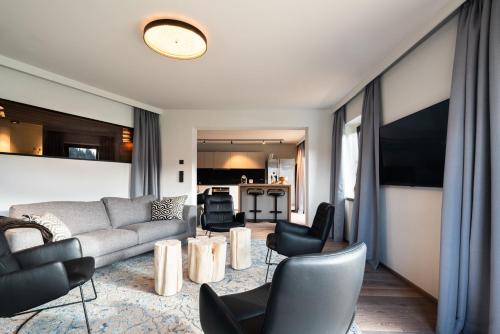 a living room with a couch and chairs at KaiserMoments in Going