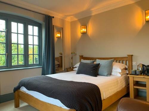 a bedroom with a large bed with blue pillows at The Mooring Post in Gloucester