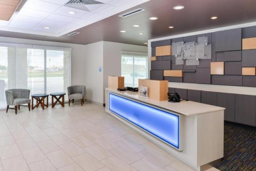 an office lobby with a reception desk and chairs at Holiday Inn Express & Suites - Ogallala by IHG in Ogallala