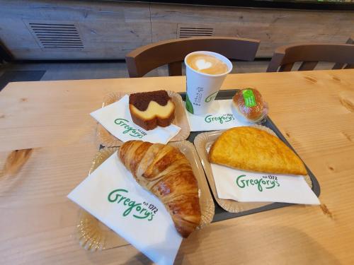 a tray of bread and pastries on a table at Upground Residence Apartments in Bucharest