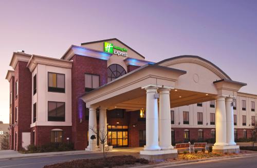 a hotel building with a sign on top of it at Holiday Inn Express & Suites Pine Bluff/Pines Mall by IHG in Pine Bluff