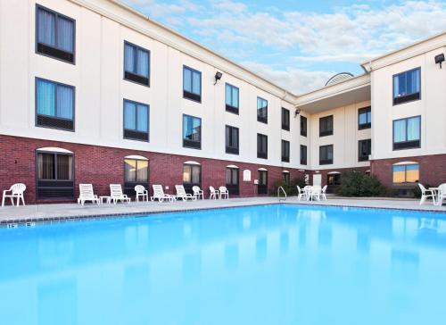 a large swimming pool in front of a hotel at Holiday Inn Express & Suites Pine Bluff/Pines Mall by IHG in Pine Bluff