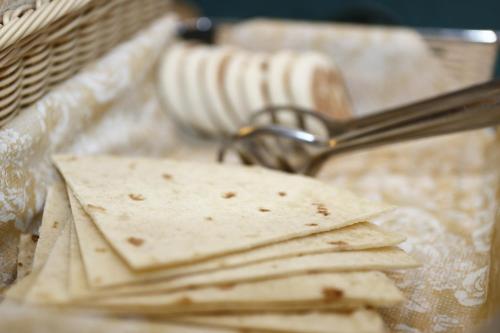 a tray of crackers sitting on top of a table at Hotel Estense in Modena