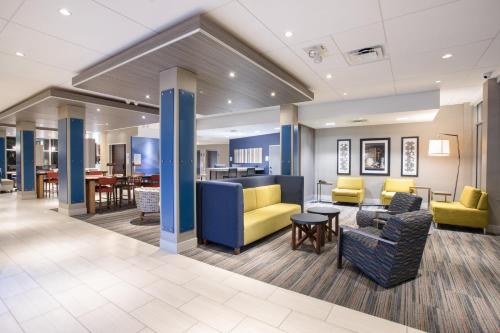 a lobby of a hospital with chairs and tables at Holiday Inn Express & Suites - Denver NE - Brighton, an IHG Hotel in Brighton