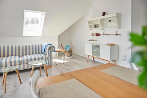 a living room with a couch and a table at Liegeplatz Appartements in Fockbek