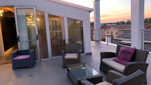 a balcony with chairs and a couch and a table at Hotel In - Lounge Room in Cazzago di Pianiga