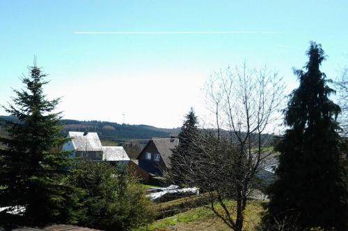 a group of trees on a hill with houses at Ferienwohnungen! Kleine Bungalows mit Terrasse! in Stockhausen-Illfurth