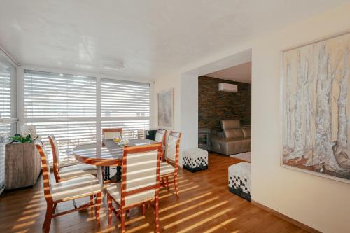 a dining room with a table and chairs at Apartments in Villa Olimp in Ljubljana