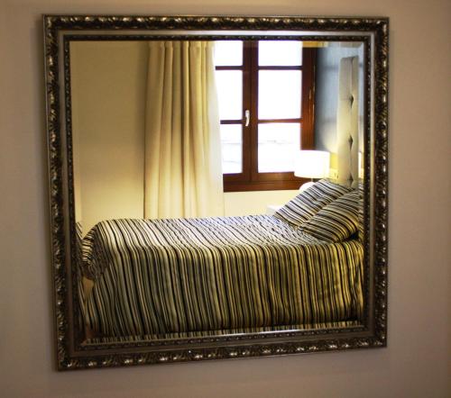 Ένα ή περισσότερα κρεβάτια σε δωμάτιο στο Hotel Palau dels Osset