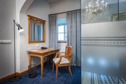 a room with a table and chairs and a window at Monastery Garden Prague in Prague