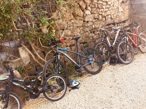 a group of bikes parked next to a stone wall at Fort de la Bastide in Uzer