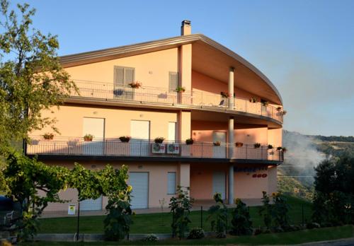 a building with a balcony with people on it at Hotel 660 in Bisignano