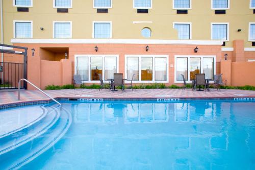 a swimming pool in front of a building at Holiday Inn Express & Suites - Jourdanton-Pleasanton, an IHG Hotel in Jourdanton