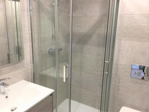 une douche avec une porte vitrée à côté d'un lavabo dans l'établissement STUDIO HYPERCENTRE-101, à Nice