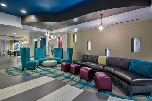 a lobby with a couch and chairs in a room at Holiday Inn Express & Suites Carlisle - Harrisburg Area by IHG in Carlisle