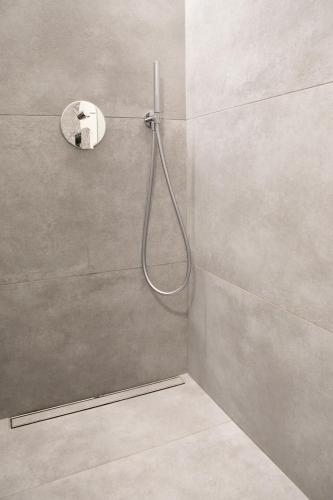 a shower with a hose in a bathroom at IseoLakeRental - La Villina - Zù in Riva di Solto